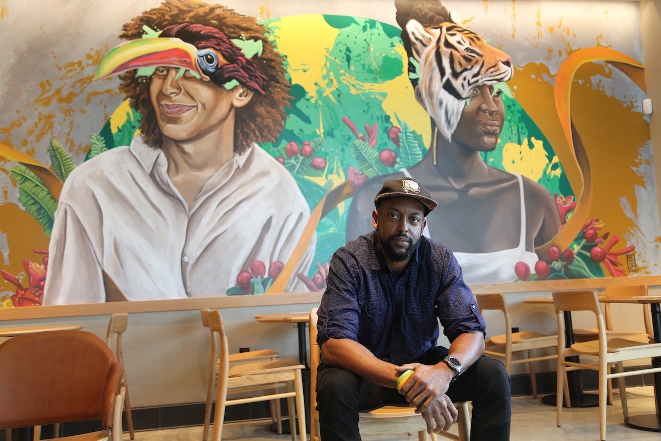 Artist Nate Dee with the mural he painted inside the new Starbucks Community Store in Fort Lauderdale.