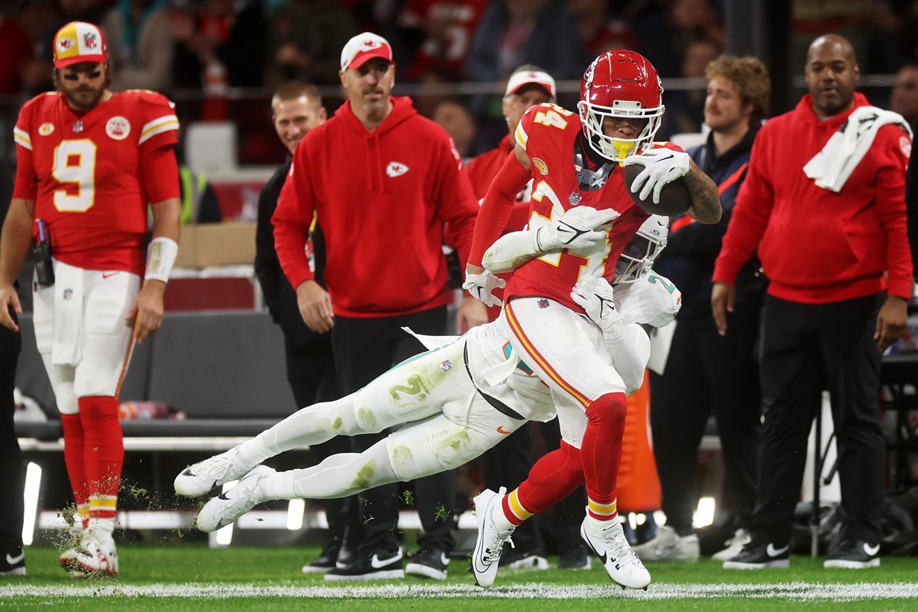DeShon Elliott of the Miami Dolphins wraps up Skyy Moore of the Kansas City Chiefs at Deutsche Bank Park on November 05, 2023 in Frankfurt, Germany.