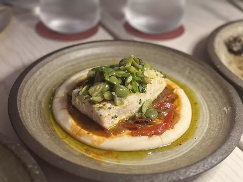 Image: The olive oil-poached Atlantic swordfish on a white bean puree with Sicilian olives and charred peppers from Salt + Ash.