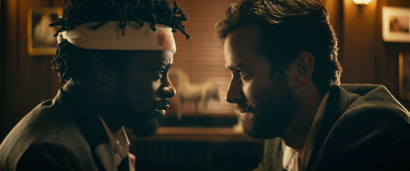 Lakeith Stanfield (left) plays Cassius “Cash” Green and Armie Hammer is Steve Lift, a coke-sniffing imbecile rich boy, in Sorry to Bother You, Boots Riley’s profoundly hilarious directorial debut.