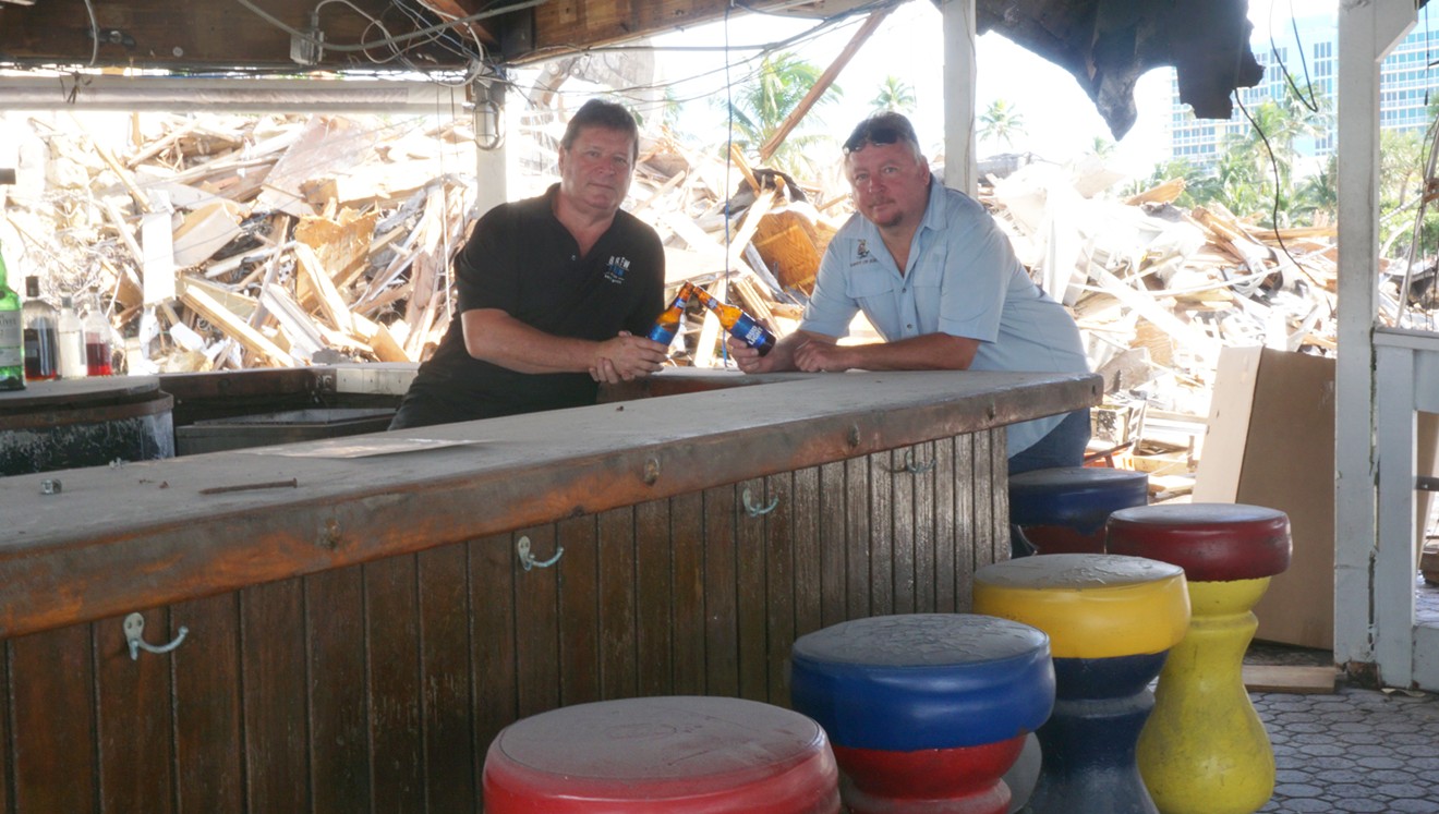 From left: Jeff Hallick and Jeff Ryan share a final toast at Bahia Cabana's iconic tiki bar, which will be reduced to rubble by next week.