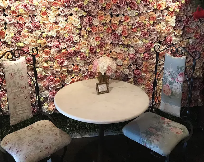 Ann's Rose Wall is a cherished staple of the Las Olas all-in-one coffee, wine, and flower shop. - AYURELLA HORN-MULLER