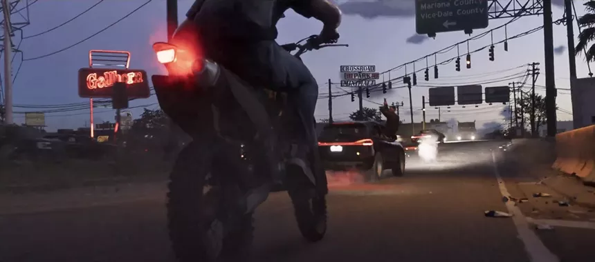 video game screenshot showing a motorcycle on a street in an industrial area