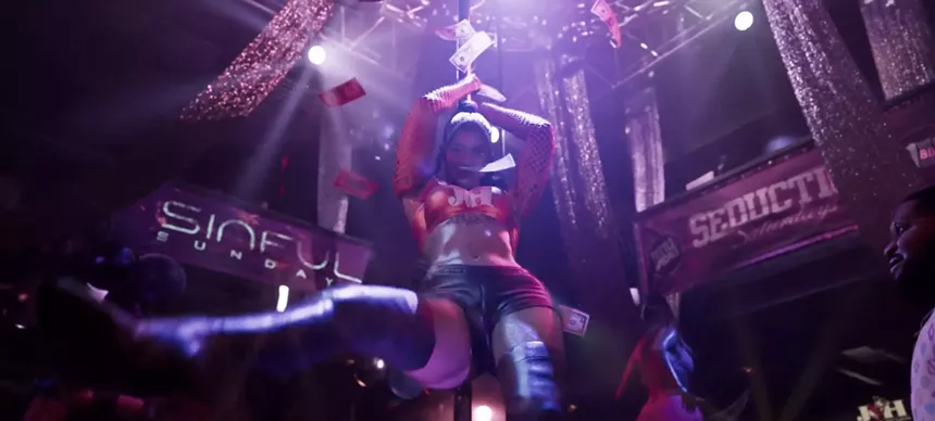 video game screenshot of the interior of a stripclub featuring a pole dancer and floating dollar bills