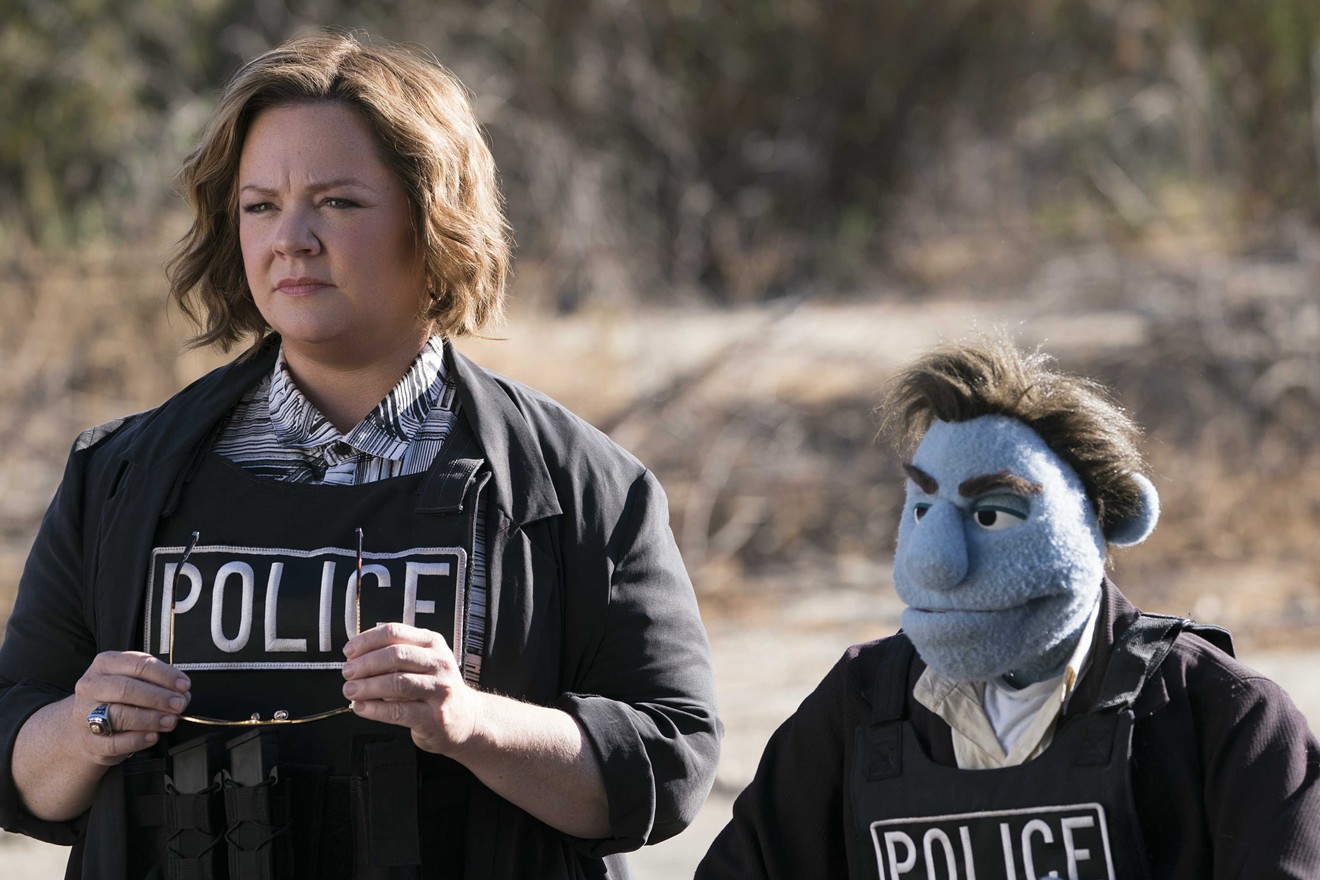 Melissa McCarthy plays detective Connie Edwards, who works with puppet-partner Phil Philips (performed by Bill Barretta), in The Happytime Murders, a comedy directed by Brian Henson, the son of late puppet master Jim Henson.